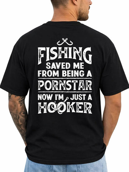 A man shown from the back wearing a black t-shirt with a humorous white graphic text print that reads 'FISHING SAVED ME FROM BEING A PORNSTAR NOW I'M JUST A HOOKER' with a fishing line and hook design.