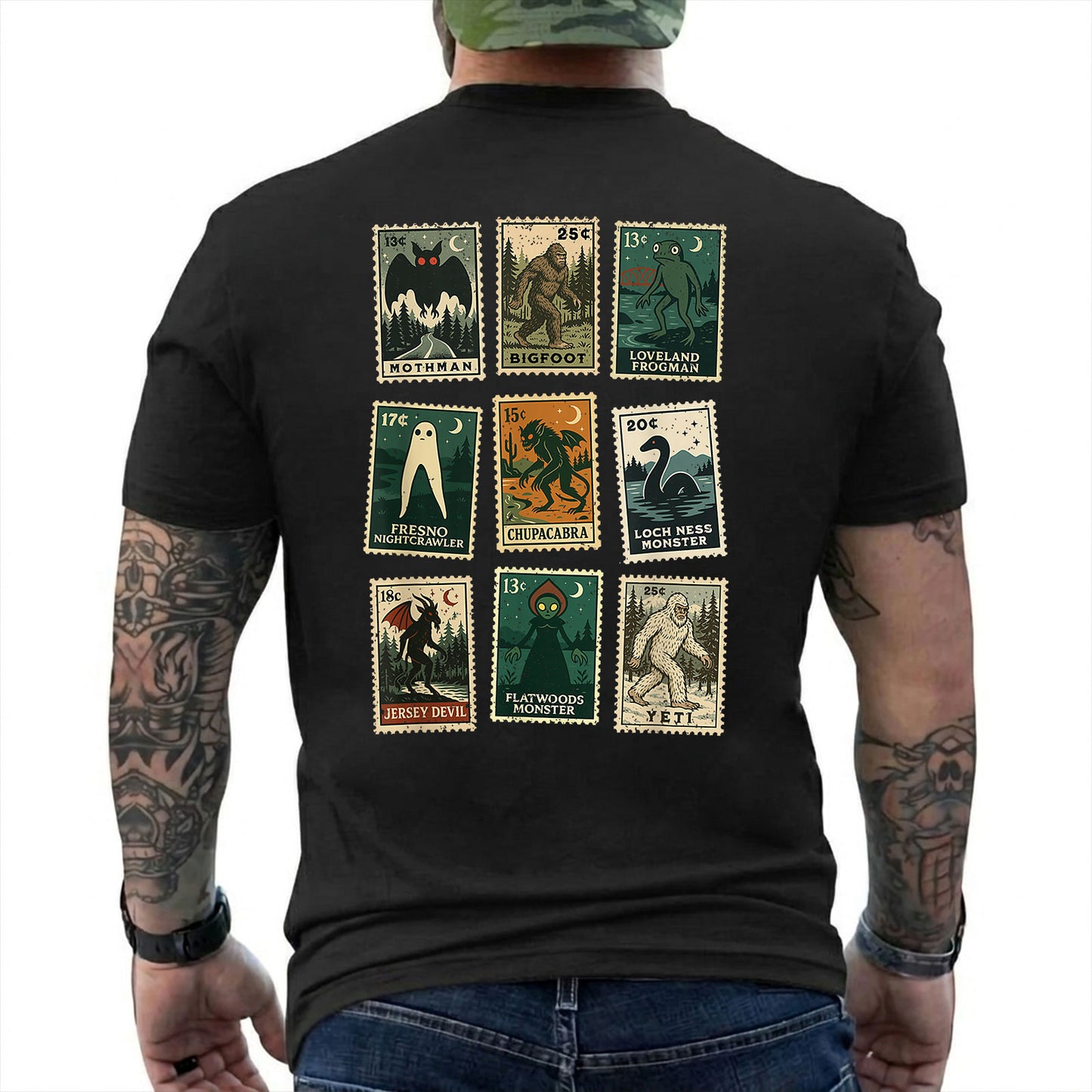 Black T-shirt back with nine vintage-style cryptid stamps featuring Mothman, Bigfoot, and other legendary creatures reading 'MOTHMAN BIGFOOT LOVELAND FROGMAN FRESNO NIGHTCRAWLER CHUPACABRA LOCH NESS MONSTER JERSEY DEVIL FLATWOODS MONSTER YETI'