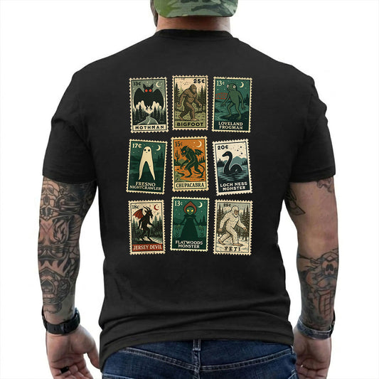Black T-shirt back with nine vintage-style cryptid stamps featuring Mothman, Bigfoot, and other legendary creatures reading 'MOTHMAN BIGFOOT LOVELAND FROGMAN FRESNO NIGHTCRAWLER CHUPACABRA LOCH NESS MONSTER JERSEY DEVIL FLATWOODS MONSTER YETI'