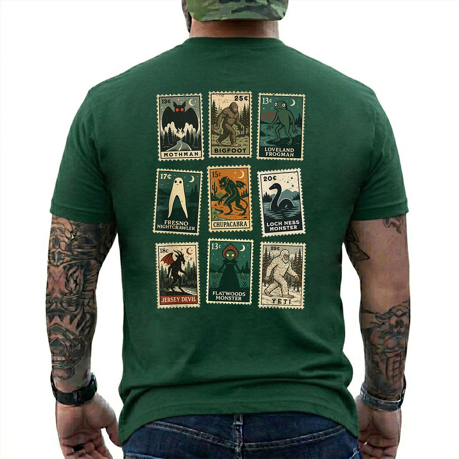 Forest Green T-shirt back with nine vintage-style cryptid stamps featuring Mothman, Bigfoot, and other legendary creatures