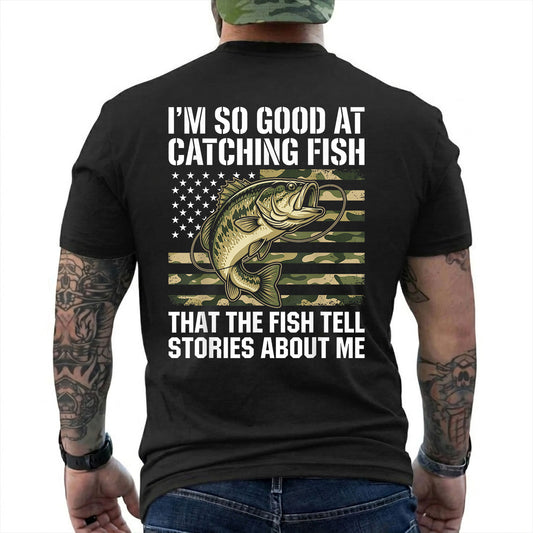 Black T-shirt back with bass over a camouflage American flag and Fish Tell Stories back slogan reading 'I'M SO GOOD AT CATCHING FISH THAT THE FISH TELL STORIES ABOUT ME'