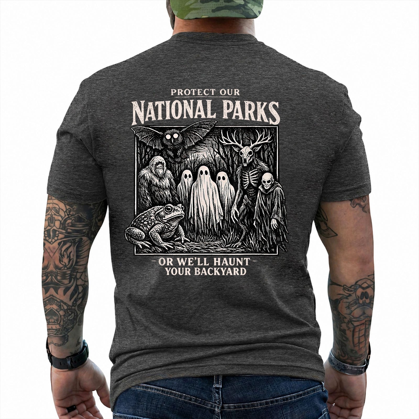 Dark Heather T-shirt back with black-and-white cryptid collage with ghosts, Bigfoot, Mothman, a frog, and skeletal figures