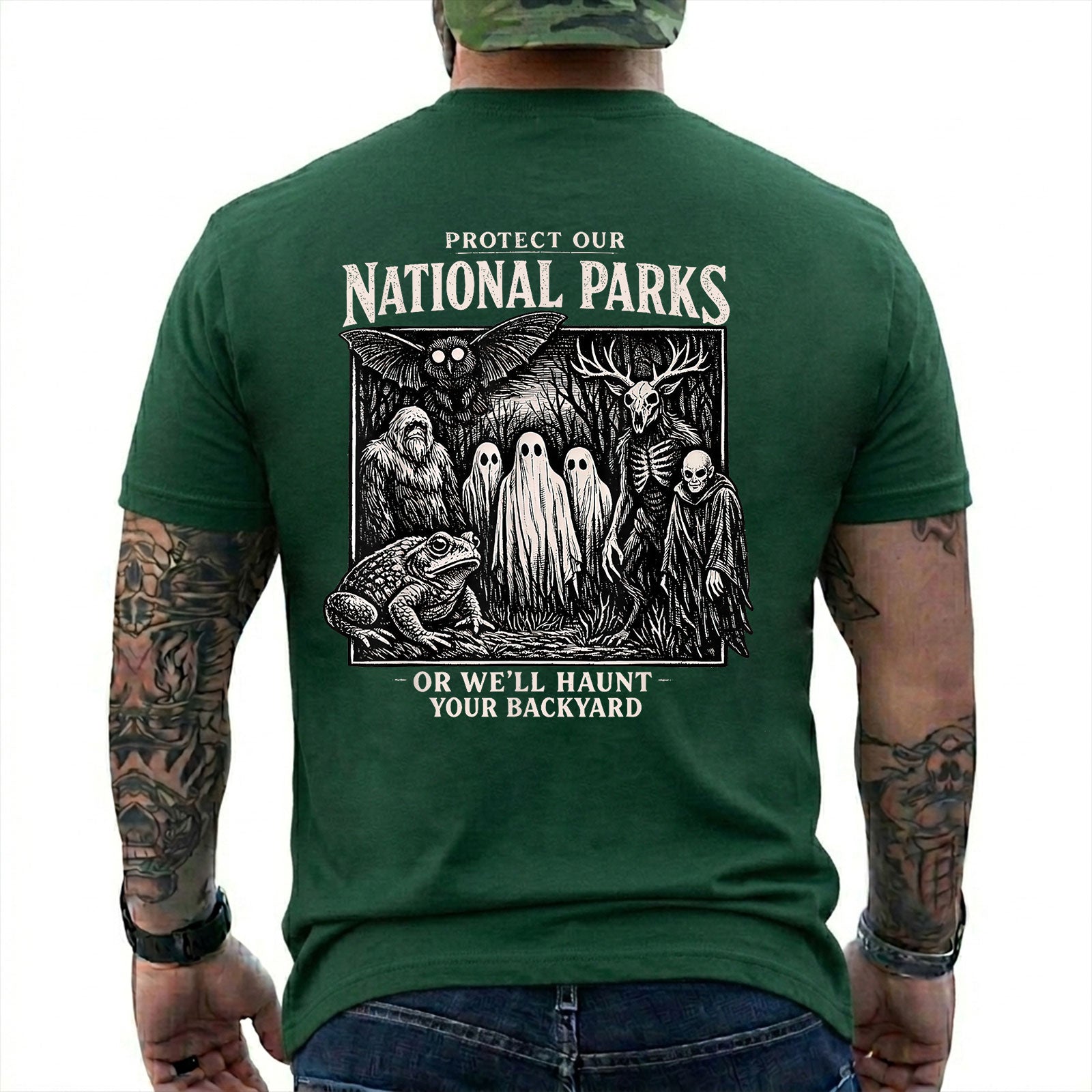 Forest Green T-shirt back with black-and-white cryptid collage with ghosts, Bigfoot, Mothman, a frog, and skeletal figures