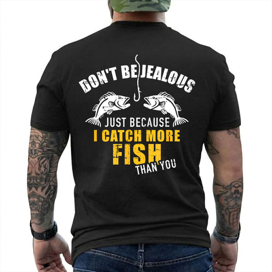 Black T-shirt back with two fish, hook, and I Catch More Fish Than You back slogan reading 'DON'T BE JEALOUS JUST BECAUSE I CATCH MORE FISH THAN YOU'