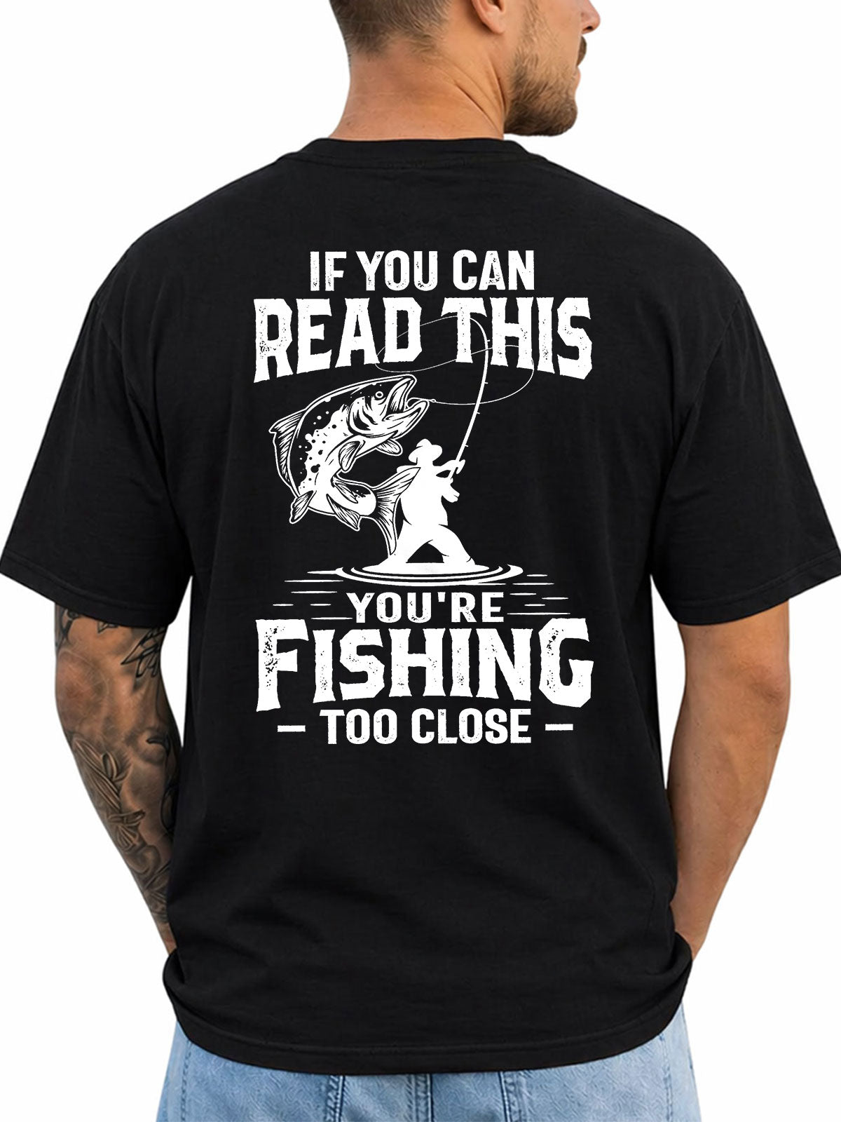 Black T-shirt back with distressed angler and leaping fish warning graphic reading 'IF YOU CAN READ THIS YOU'RE FISHING TOO CLOSE'