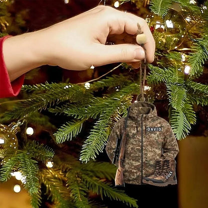 Camo hunter jacket ornament with a custom name hanging on a lit Christmas tree