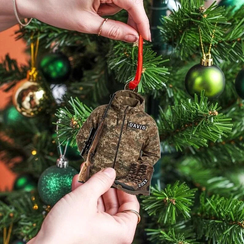 Hand placing a personalized camo hunter jacket ornament on a Christmas tree