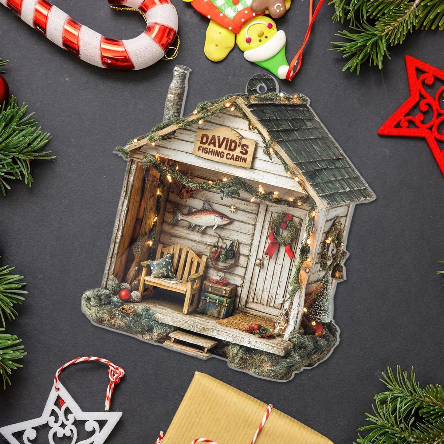 Fishing cabin ornament flat lay with a custom name sign and Christmas decorations