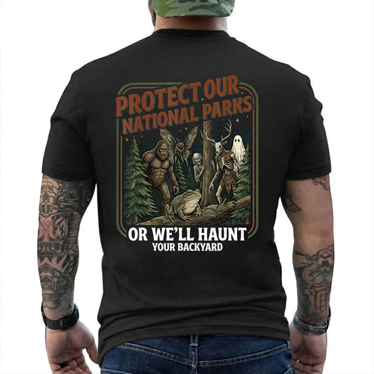 Protect Our National Parks Cryptid Forest T-Shirt artwork detail with color forest poster with Bigfoot, Mothman, a frog, ghosts, and a deer-skull creature reading 'PROTECT OUR NATIONAL PARKS OR WE'LL HAUNT YOUR BACKYARD'
