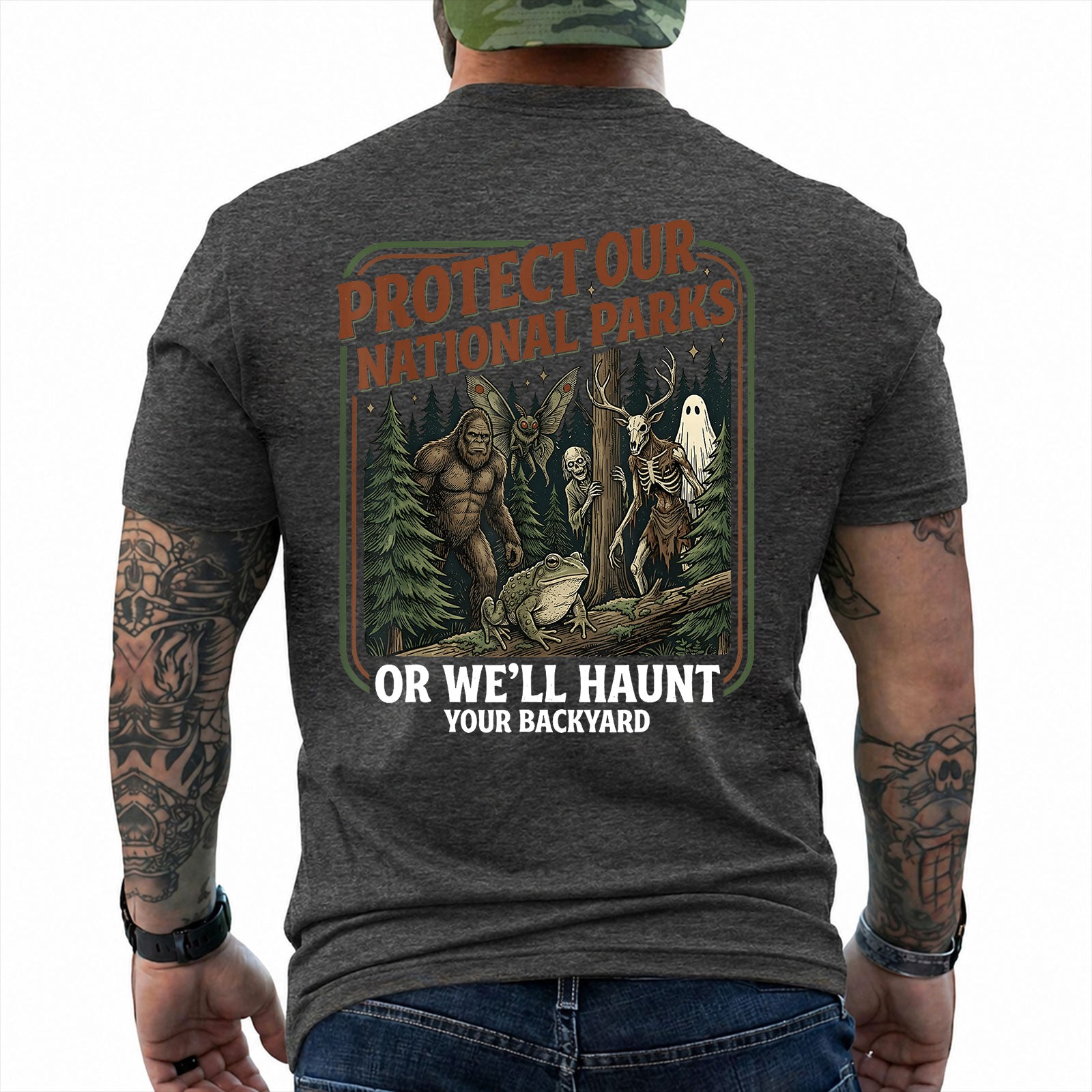 Dark Heather T-shirt back with color forest poster with Bigfoot, Mothman, a frog, ghosts, and a deer-skull creature