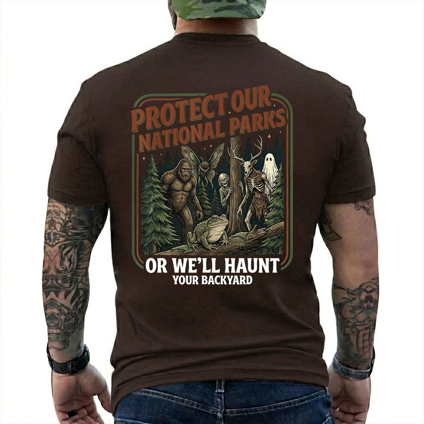 Dark Chocolate T-shirt back with color forest poster with Bigfoot, Mothman, a frog, ghosts, and a deer-skull creature