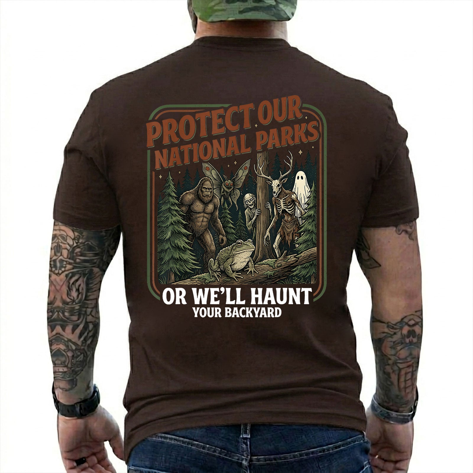 Dark Chocolate T-shirt back with color forest poster with Bigfoot, Mothman, a frog, ghosts, and a deer-skull creature