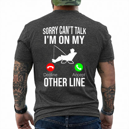 Dark Heather T-shirt back with seated angler, fishing line, and phone-call Other Line joke