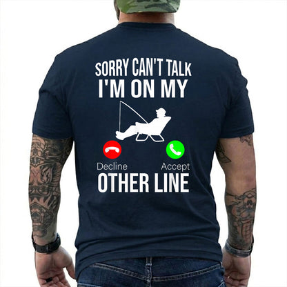 Forest Green T-shirt back with seated angler, fishing line, and phone-call Other Line joke