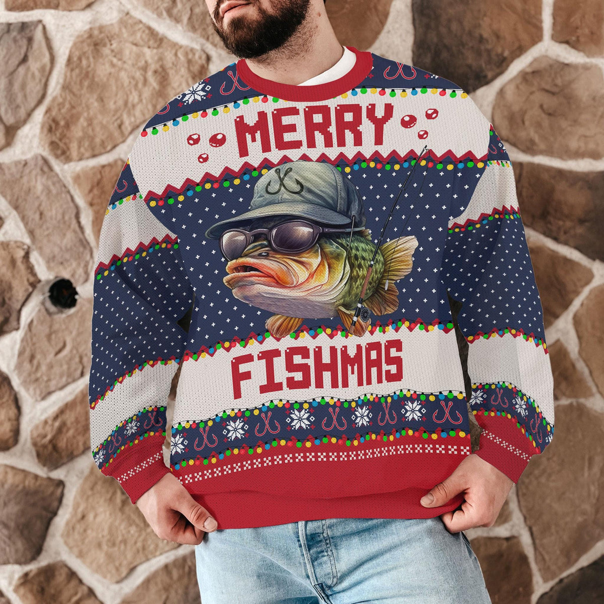 Man wearing the Merry Fishmas bass sweater against a stone wall