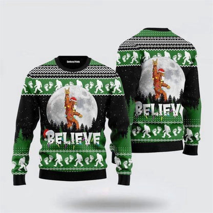 Front and back of a green and black sweater with Bigfoot in a Santa suit and the word Believe