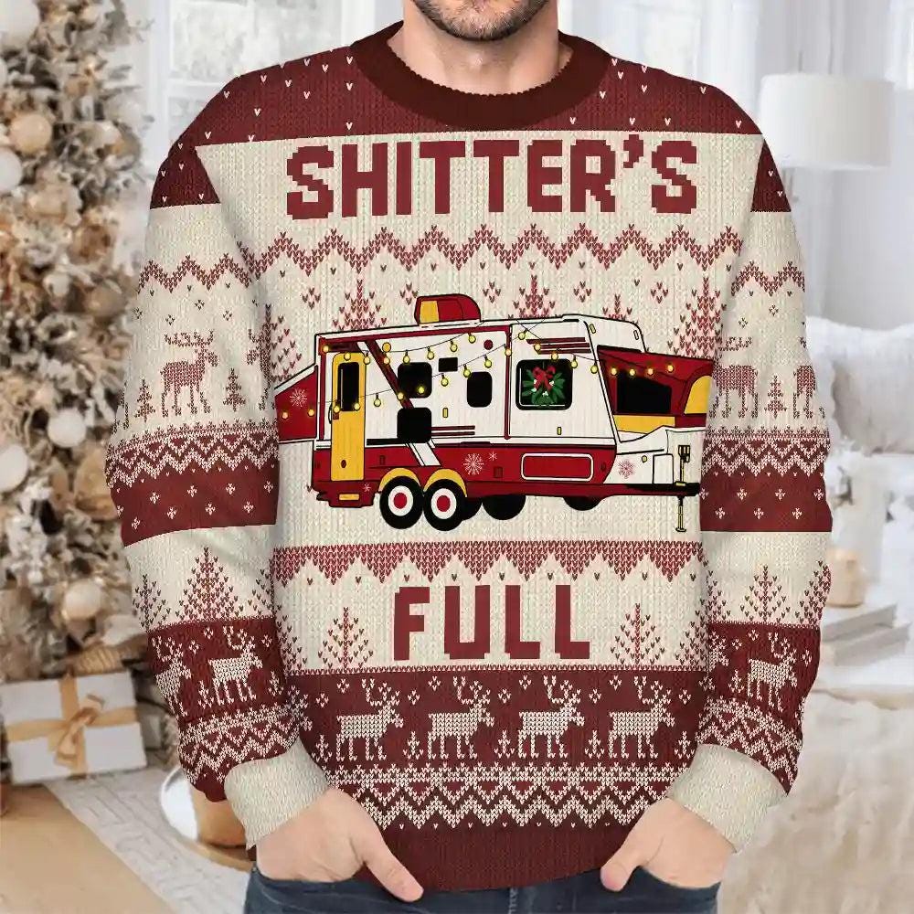 Man wearing a maroon Shitter's Full sweater with a travel trailer