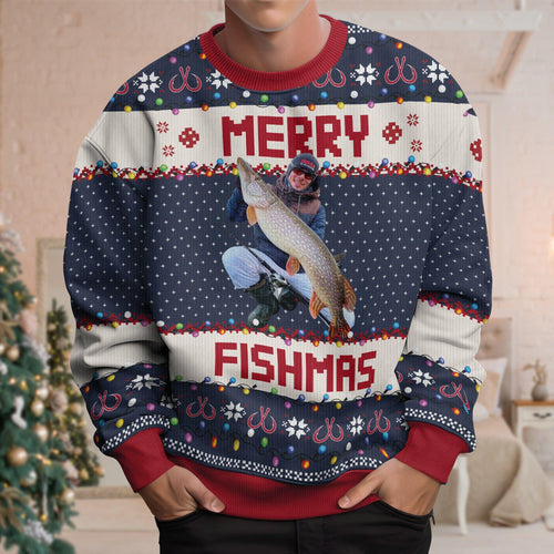 Man wearing a navy Merry Fishmas sweater with a printed photo of an angler holding a pike