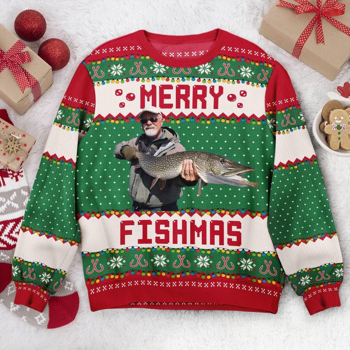 Green Merry Fishmas sweater flat with a photo of a bearded angler holding a northern pike