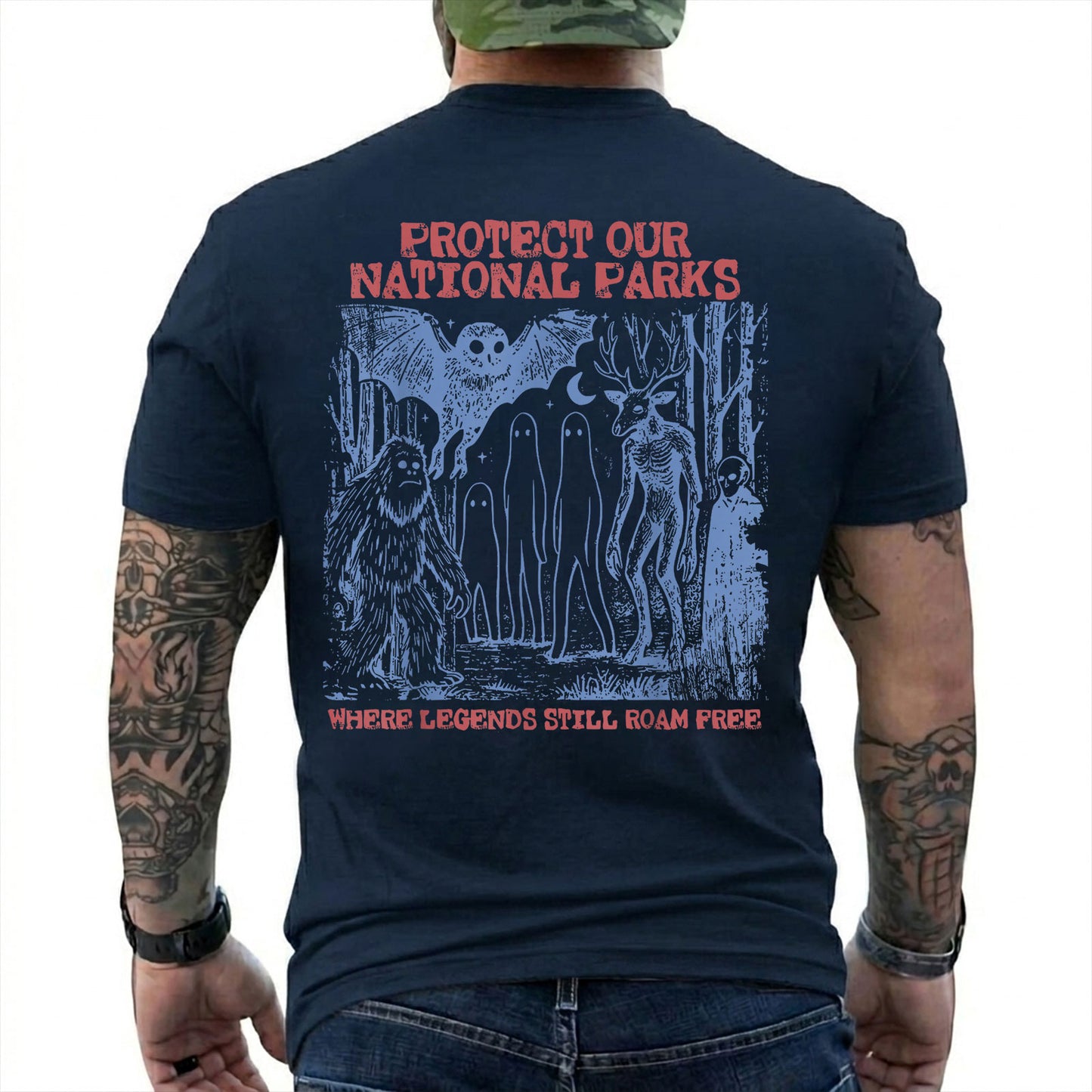 Navy T-shirt back with blue forest cryptids beneath red Protect Our National Parks lettering