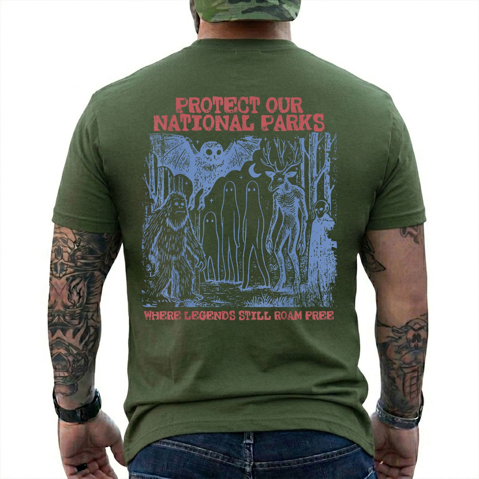 Military Green T-shirt back with blue forest cryptids beneath red Protect Our National Parks lettering
