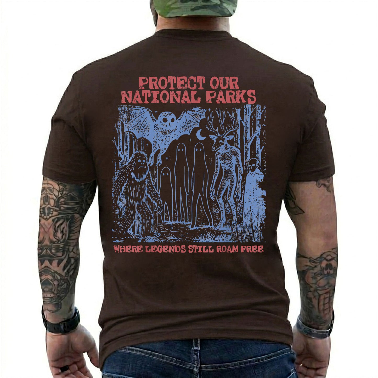 Dark Chocolate T-shirt back with blue forest cryptids beneath red Protect Our National Parks lettering