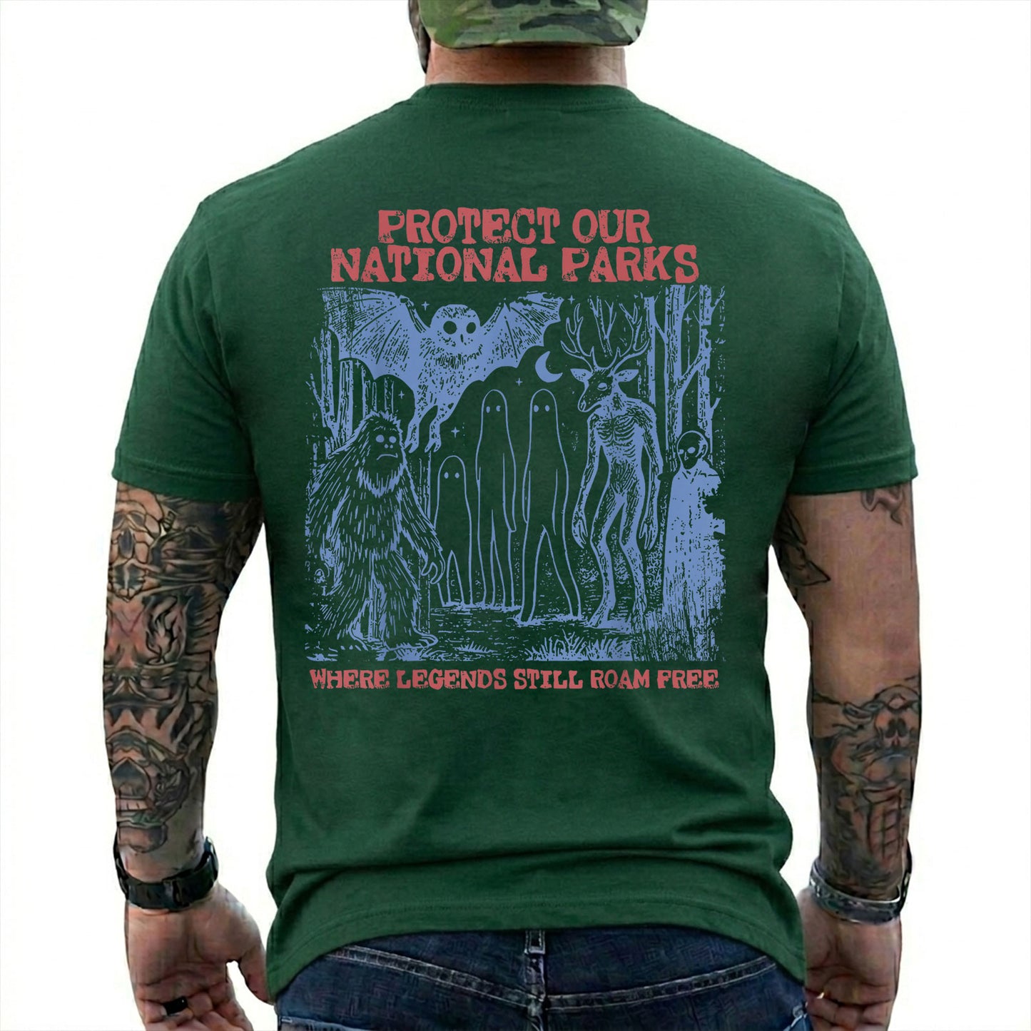 Forest Green T-shirt back with blue forest cryptids beneath red Protect Our National Parks lettering
